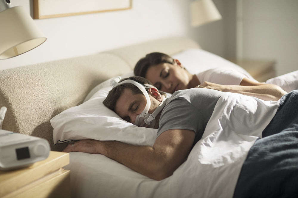 Man sleeping on his stomach wearing full face mask