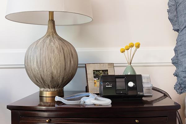 AirFit™ N30 mask sitting on nightstand with AirSense™ 10 device