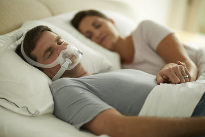 Man sleeping on his back wearing full face mask