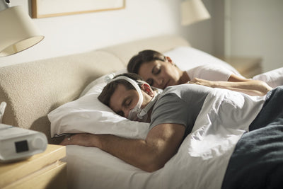 Man sleeping on his stomach wearing full face mask