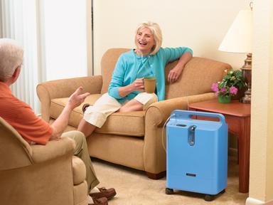 Woman chatting with friend in living room with EverFlo on floor next to her