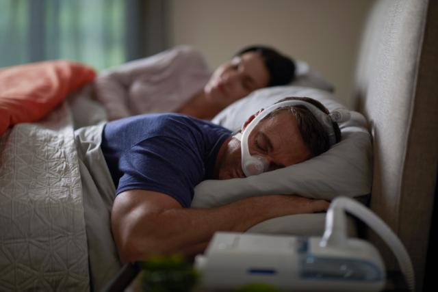 Man sleeping on his stomach wearing nasal mask